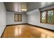 Bright bedroom featuring hardwood floors, unique window, and a decorative ceiling light at 6001 Sweet Gum Run, Bartow, FL 33830
