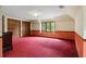 Large bedroom with floral wallpaper, diamond pane window, and closet at 6001 Sweet Gum Run, Bartow, FL 33830