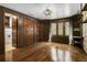 Bedroom with two windows, hardwood floors, a stylish light fixture, and a walk in closet at 6001 Sweet Gum Run, Bartow, FL 33830