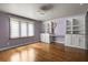 Bedroom with built in desk and cabinet storage, light purple walls, hardwood floors and light-filtering blinds at 6001 Sweet Gum Run, Bartow, FL 33830