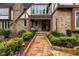 Inviting front entrance with a stone pathway, brick facade, and manicured landscaping at 6001 Sweet Gum Run, Bartow, FL 33830