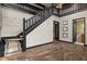 Welcoming foyer with elegant hardwood flooring, staircase, and access to other rooms in the home at 6001 Sweet Gum Run, Bartow, FL 33830