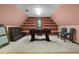 Finished attic space as game room with foosball table, shelves, and two chairs at 6001 Sweet Gum Run, Bartow, FL 33830