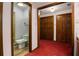 Hallway view of bathroom and bedroom closet, with dark-stained wood trim at 6001 Sweet Gum Run, Bartow, FL 33830