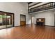 Open-concept living room with hardwood floors, a piano, and sliding doors to the patio at 6001 Sweet Gum Run, Bartow, FL 33830