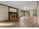 Elegant living room featuring hardwood floors, fireplace, and multiple doorways offering seamless flow at 6001 Sweet Gum Run, Bartow, FL 33830