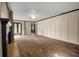 Elegant living room featuring hardwood floors, fireplace, and multiple doorways offering seamless flow at 6001 Sweet Gum Run, Bartow, FL 33830