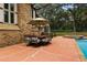 Screened patio with brick exterior and dining set and an outdoor in-ground pool at 6001 Sweet Gum Run, Bartow, FL 33830