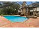 Enclosed pool with screened enclosure, spa, and waterfall feature at 6001 Sweet Gum Run, Bartow, FL 33830