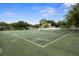 Full tennis court ready for play, perfect for sports enthusiasts in a neighborhood community at 6001 Sweet Gum Run, Bartow, FL 33830