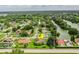 Neighborhood view showcasing the home's setting amidst lush greenery near a serene lake at 6134 Christina E Dr, Lakeland, FL 33813