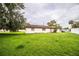 Expansive backyard of single-story home, offering plenty of room for outdoor activities and gardening at 6134 Christina E Dr, Lakeland, FL 33813