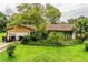 Charming single-story home with mature trees and lush landscaping in a desirable neighborhood at 6134 Christina E Dr, Lakeland, FL 33813