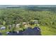 Aerial view of waterfront property with sprawling land, private dock, and mature trees at 6281 Halabrin Rd, Haines City, FL 33844