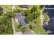 Aerial view of home and property with mature trees and dock on the lake at 6281 Halabrin Rd, Haines City, FL 33844