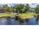 Scenic view showcases a lakeside property with private dock, and lush landscape at 6281 Halabrin Rd, Haines City, FL 33844