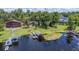 Aerial view of a waterfront home with lush greenery, private dock, and serene water at 6281 Halabrin Rd, Haines City, FL 33844