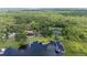 Aerial view of a lakeside property with multiple docks and lush green surroundings at 6281 Halabrin Rd, Haines City, FL 33844