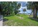 Lush backyard leads to a wooden dock, providing direct lake access and scenic views at 6281 Halabrin Rd, Haines City, FL 33844