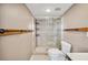 Bathroom featuring a shower, toilet, wooden towel racks, and tile flooring at 6281 Halabrin Rd, Haines City, FL 33844