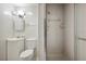 This bathroom shows a standard toilet, vanity, and stand up shower with glass doors at 6281 Halabrin Rd, Haines City, FL 33844