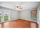 Bedroom featuring hardwood floors, ceiling fan, and french doors that leads outside at 6281 Halabrin Rd, Haines City, FL 33844