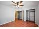 Bedroom with wood floors, ceiling fan, and closet, offering plenty of storage space at 6281 Halabrin Rd, Haines City, FL 33844