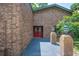 Brick house entrance with stylish red double-doors and a well maintained front yard at 6281 Halabrin Rd, Haines City, FL 33844