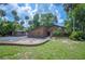 Charming brick home featuring a landscaped yard, mature trees, and a brick mailbox at 6281 Halabrin Rd, Haines City, FL 33844