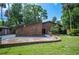 Charming brick home featuring a landscaped yard, mature trees, and a brick mailbox at 6281 Halabrin Rd, Haines City, FL 33844