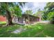 Exterior view of brick home with brick chimney and expansive yard at 6281 Halabrin Rd, Haines City, FL 33844