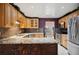 Spacious kitchen with granite countertops, stainless steel appliances and wooden cabinets at 6281 Halabrin Rd, Haines City, FL 33844