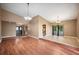 Open-concept living room with hardwood floors, chandelier, and sliding glass doors to a lanai at 6281 Halabrin Rd, Haines City, FL 33844