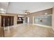 Spacious living room with tile flooring and view into kitchen and large sliding door at 6281 Halabrin Rd, Haines City, FL 33844
