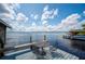 Scenic lake view from waterfront deck with table and chairs and boat dock in the background at 6281 Halabrin Rd, Haines City, FL 33844