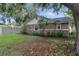 Home's backyard with well-maintained lawn, small shrubbery, and partial fencing at 6342 Butternut Dr, Lakeland, FL 33813