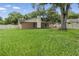 Home's spacious backyard with well-maintained lawn, perimeter fencing, and a pergola at 6342 Butternut Dr, Lakeland, FL 33813
