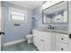 Bathroom showcasing a white vanity, sleek black fixtures, and artistic floor at 6342 Butternut Dr, Lakeland, FL 33813