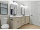 Bright bathroom with dual sinks, black hardware, and granite countertops at 6342 Butternut Dr, Lakeland, FL 33813