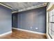 Bedroom featuring a large window, hardwood floors, and neutral wall color at 6342 Butternut Dr, Lakeland, FL 33813
