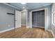 Bedroom offers a closet with ample storage, an entrance to another room, and hardwood floors at 6342 Butternut Dr, Lakeland, FL 33813