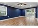 Spacious bedroom with fan, hardwood floors, sliding door to the backyard, and window at 6342 Butternut Dr, Lakeland, FL 33813
