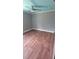 This bedroom is painted light gray and has wood flooring and a ceiling fan at 6342 Butternut Dr, Lakeland, FL 33813