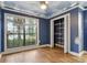 Charming bedroom featuring a whimsical blue sky ceiling, hardwood floors, and ample natural light at 6342 Butternut Dr, Lakeland, FL 33813