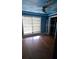 Bedroom featuring blue walls, a ceiling fan, a window, and a closet at 6342 Butternut Dr, Lakeland, FL 33813