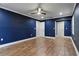 Spacious bedroom with fan, hardwood floors, and natural light from the multiple doors at 6342 Butternut Dr, Lakeland, FL 33813