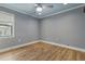 Bedroom features a ceiling fan and ample natural light streaming in from the window at 6342 Butternut Dr, Lakeland, FL 33813