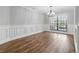 Bright dining room features beautiful hardwood floors and custom trim work, creating an elegant space at 6342 Butternut Dr, Lakeland, FL 33813