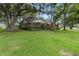 Landscaped home featuring a large yard, mature trees, and privacy at 6342 Butternut Dr, Lakeland, FL 33813