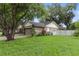 Beautiful home featuring lush green grass, side-entry garage, and a fenced yard at 6342 Butternut Dr, Lakeland, FL 33813